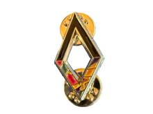 A gold-toned diamond-shaped lapel pin with red and green enamel accents, shown from the side.